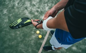 Tennis player adjusting his sweat bands